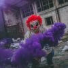 Red Headed Halloween Clown with Purple Smoke in a warehouse