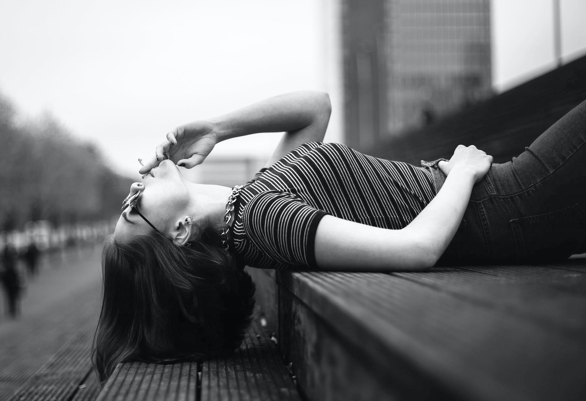 woman laying on her back smoking a joint