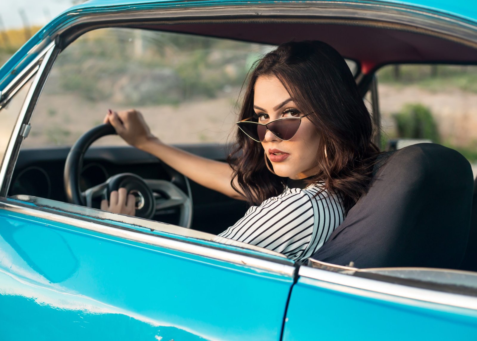 woman driving blue vintage car